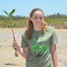 Forest Heights Academy student plants her last seedling.