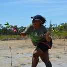 Even after sinking in the mud, this Forest Heights Academy student is excited to plant her mangroves.