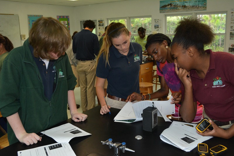 NOAA Knauss Fellow, Symone Johnson helping students at Forest Heights to use a GPS device.