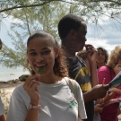 Students from Forest Heights Academy taste a black mangrove leaf. Even though it has been raining a lot, the students find out that the leaves are still very salty!