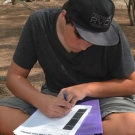 10th grade Biology student draws leaves of the black, red, and white mangrove tree to help him later remember how to identify each.