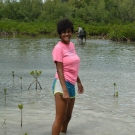 10th grade student at Forest Heights Academy collects three red mangrove seedlings that she will grow and care for during the next eight months in her Biology class.