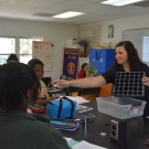 Our Director of Education, Amy Heemsoth shows students how they are going to plant their mangrove seedings in these plant flats.