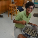 It looks like this Forest Heights Academy student is finished adding sand to this plant flat. We are now ready to plant the seedings.