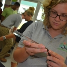 Forest Heights student takes an initial growth measurement of her mangrove seedling. She and her classmates will continue to measure the growth of each seedling over the next 8 months.