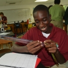 This student takes the first measurement of his mangrove seedling. He will record this data in his mangrove journal.