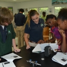 NOAA Knauss Fellow, Symone Johnson helping students at Forest Heights to use a GPS device.