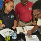 Year 2 B.A.M. participants from Forest Heights Academy, test the pH of various liquids.