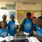 Biology students at Abaco Central High School are proud to plant their seedlings in mangrove mud.