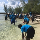 After an exciting mangrove field trip, students rinse their muddy shoes in the ocean before we head back to Abaco Central High School to plant their mangrove seedlings.