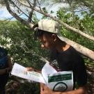 Forest Heights Academy student read instructions for how to take a pH and dissolved oxygen sample from their mangrove plot.