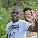 1.	A student picks up a crab climbing in the roots of the mangroves.