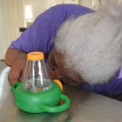 Michelle Bailey, science teacher at Abaco Central High School observes marine snails through a microviewer at FREINDS Kenyon Center Lab.