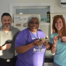 James Richard, Michelle Bailey, and Lindsey Borsz holding sea stars and sea cucumbers. These educators identified organisms in the mangroves as part of a professional development training at FRIENDS Kenyon Center Lab.