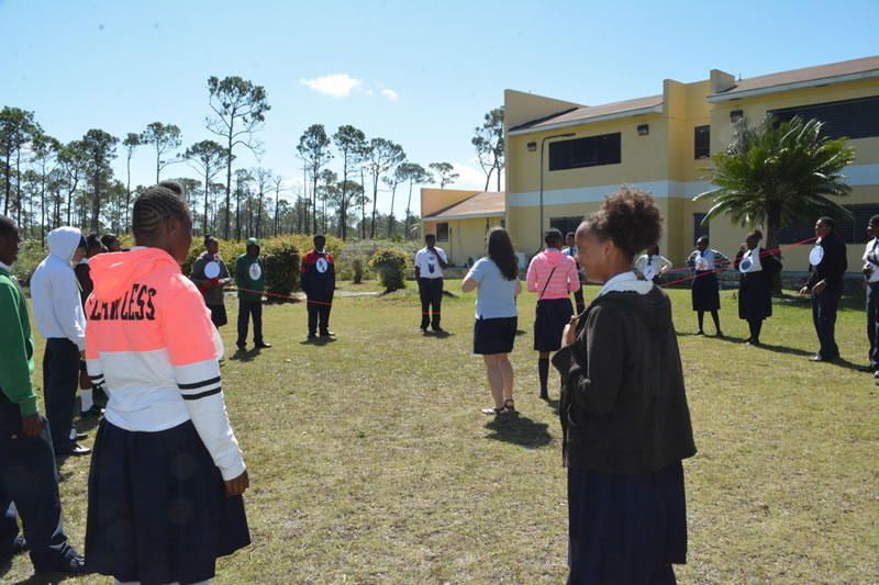 Students in the year one B.A.M. program at Abaco Central High School form a giant food web. Each student respresents an organism from the mangrove food web.