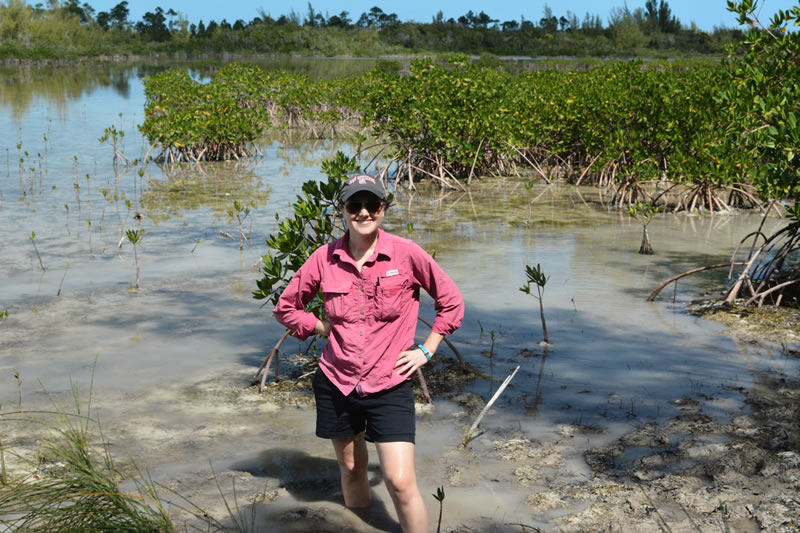 Mangrove scientist, Ryann Rossi, posing with the specimens that she studies - mangroves.