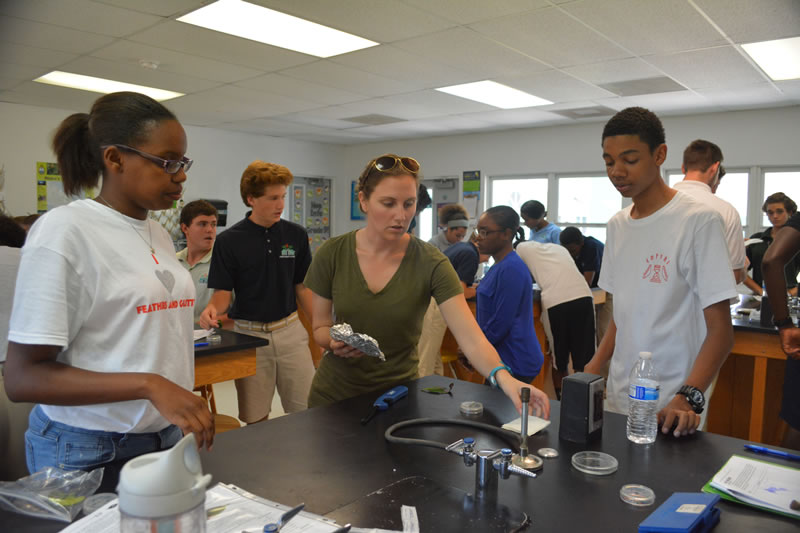 Partner from North Carolina State University, Ryann Rossi helps students to set up and sterilize their station.
