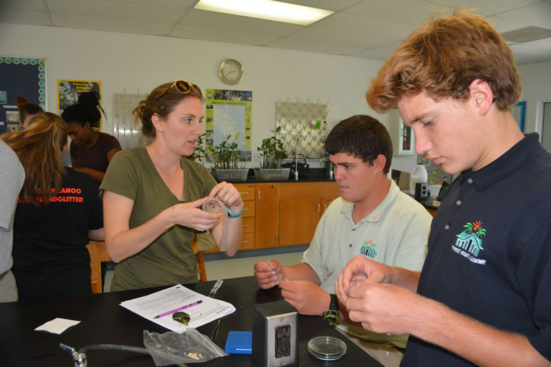 To prevent bacterial contamination, Ryann Rossi, PhD candidate at North Carolina State University shows students how to seal their agar plates with Parafilm.