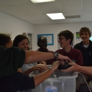 Students at Forest Heights Academy laugh when the sea cucumber jets out a stream of seawater at them.