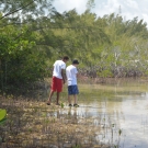 While collecting a soil sample, students at Forest Heights Academy take time to observe nature. It looks like they might have found some sort of organism in the water.