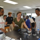 Partner from North Carolina State University, Ryann Rossi helps students to set up and sterilize their station.