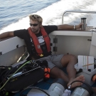 Anderson Mayfield wakes up with a cup of coffee during a long transit out to our first dive of the day.