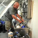 Timothy Payne II prepares tanks for a dive.