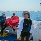 Judy Lang holds up a heart shaped ballon.