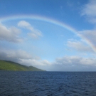 A beautiful rainbow stretching across one of the islands of Fiji.