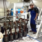 Inside the engine room, one of the German technicians wipes the sweat from his brow after lifting one of the 9 pistons from the port main engine. All of these will be taken ashore for overhaul.