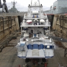 Shadow is seen from astern. Thickness measurements of the hull need to be taken at various locations above and below the waterline to ensure that the steelwork has not deteriorated. As ships age, steel plates can begin to rust, significantly reducing the strength of the hull. All ballast tanks, fuel tanks & general service tanks; rarely opened for detailed visual inspections, have to be surveyed to ensure structural integrity. A dirty job, but critical and essential. Many a ship over the years has fallen victim to corrosion, cracks and damage, so strict regulations are now in place to ensure vessels are well maintained and repaired if necessary. Luckily Shadow is in excellent condition, passing the shell survey with flying colors.