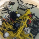 Scientists rinse off their underwater cameras in fresh water bin after diving on the Great Barrier Reef.