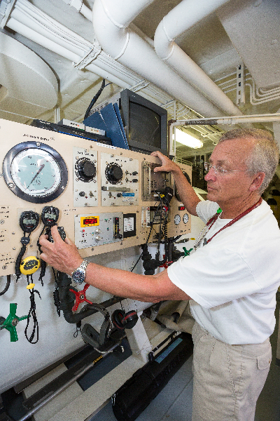 Doctor David Skinner at the controls of the hyperbaric chamber on board the M/Y Golden Shadow.