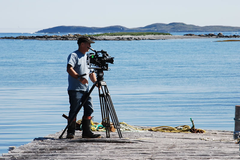Cameraman Doug Allan shooting fishing boats at the dock in Newfoundland