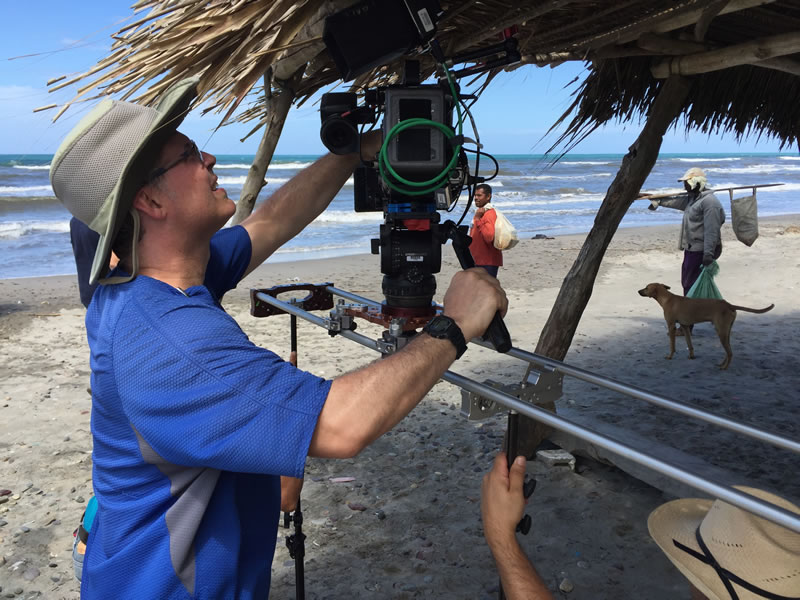 Cameraman James Ball filming on the beach in Honduras.