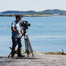 Cameraman Doug Allan shooting fishing boats at the dock in Newfoundland