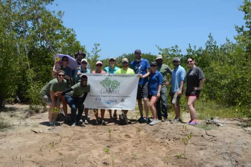 Partners from the University of the West Indies and the Living Oceans Foundation celebrate a day of hard with with volunteer alumni from Louisiana State University.