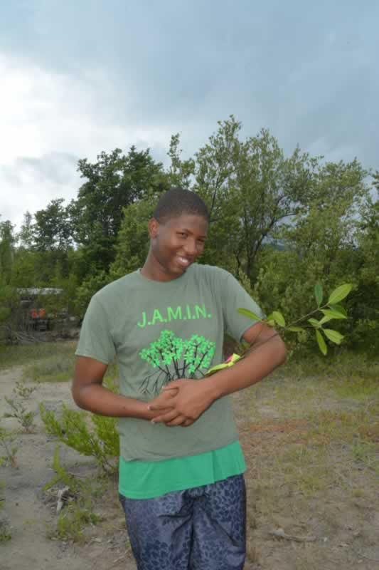 William Knibb High School student cradles his mangrove propagule signifying all of the hard work that went into caring for this seedling.