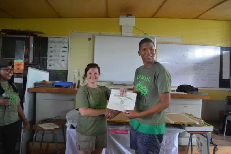 Amy Heemsoth, the Foundation's Director of Education, proudly hands out certificates of partipation to the students at William Knibb High School