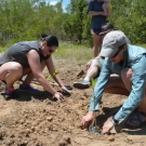 Rachel Villani and Tamra Dardenne, Louisiana State University alumni, volunteer to help restore the mangrove ecosystem in Falmouth, Jamaica.