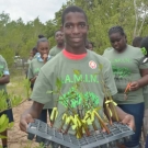 Holland High School student helps carry one of the plant flats to the restoration site. Each individual propagule was tagged with flagging tape.