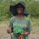 Hats are not only good for sun protection, but also shelter from the rain. This William Knibb High School student is getting a real-life field experience.
