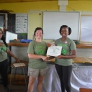 Amy Heemsoth, the Foundation's Director of Education, proudly hands out certificates of partipation to the students at William Knibb High School