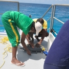 Azra Blythe-Mallett and Sean Green prepare surveying equipment.