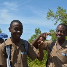 The boys show off a fiddler crab they found in the mangroves.