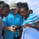 Students and Ms. Mackenzie lean in to see the BAM group photo that we took at Seville Heritage Park.