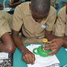 JAMIN participants at Holland High School check out the small structures of a lettuce sea slug in the microviewer.