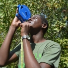 J.A.M.I.N. year 2 student from William Knibb High School familiarizes himself with using a clinometer, which is a tool used to help determine the height of trees.