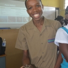 10th grade biology student from William Knibb High School is excited to be able to hold a sea biscuit. Notice how the sea biscuit is using sand and pieces of shell to camouflage itself.