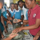 Shanna Thomas, Outreach Officer at the University of the West Indies allows students at William Knibb High School to hold sea urchins. She discusses how they are related to sea cucumbers, sand dollars, and sea stars.